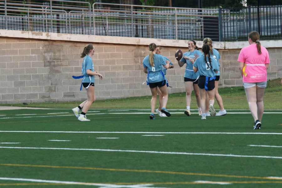 Elizabeth Joyner ‘22 celebrates with her team after scoring a touchdown. The blue team was quick to catch up with the pink team again after falling behind for a few plays. 

