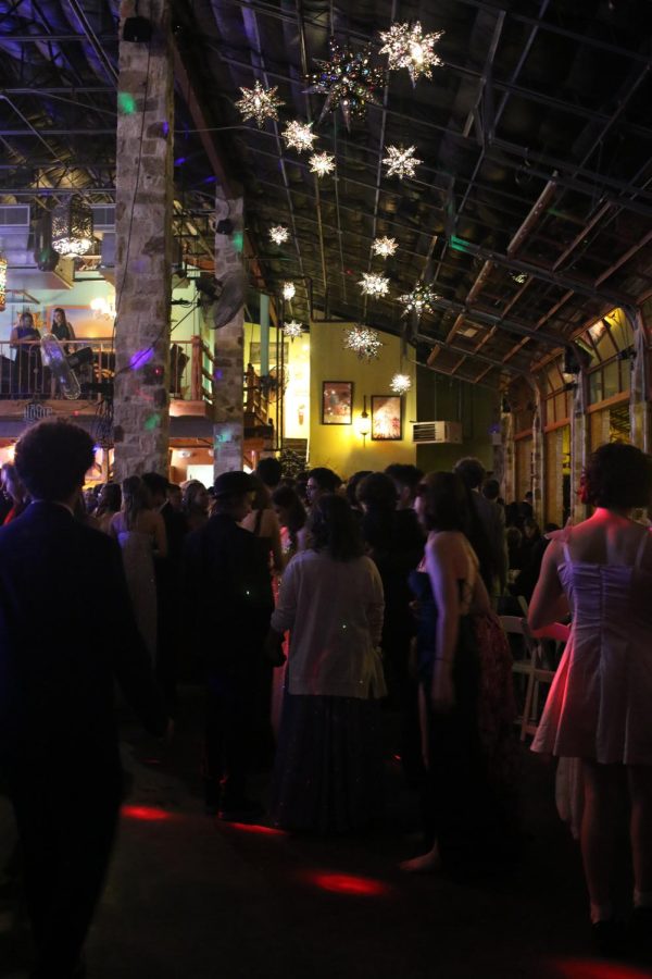 Prom attendees talk along the edges of the dance floor with their friends. The last real prom occurred in 2019, so this prom gave attendees a sense of normalcy with their friends after the pandemic. 