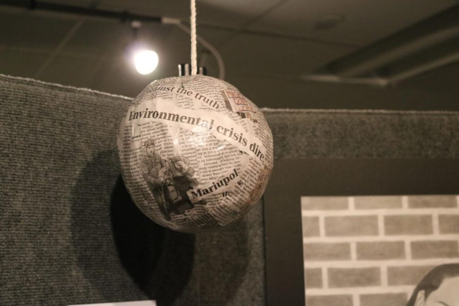Irini Skevofilax 22 centered her artwork around the theme of the feeling of despondency surrounding violence, conflicts, and wars. This paper-mache piece, titled Our World, features headlines on major issues encountered in the modern day. 
