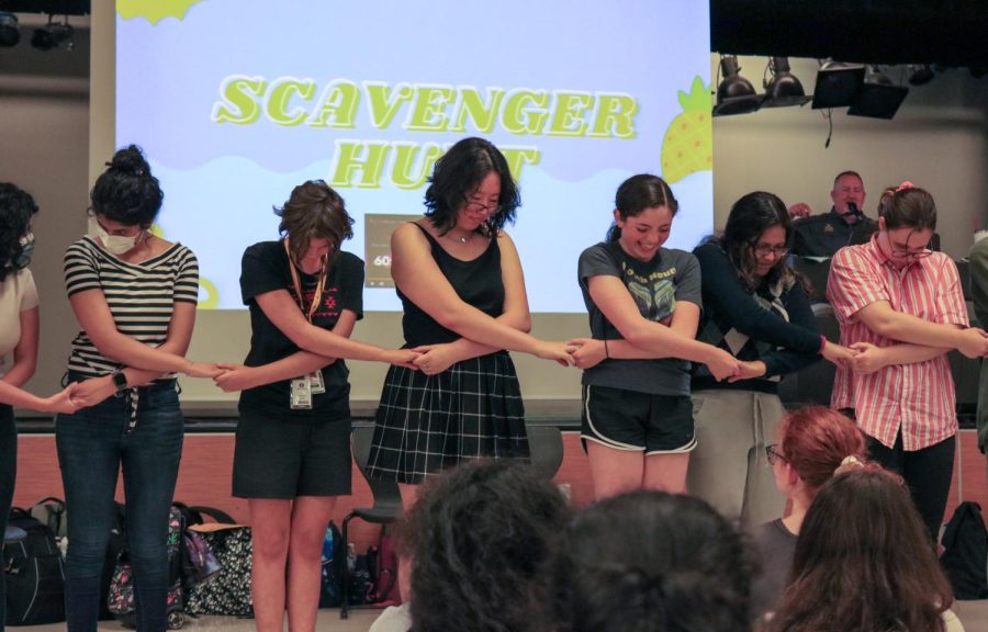 The Westwood Choirs senior hold hands as they sing 