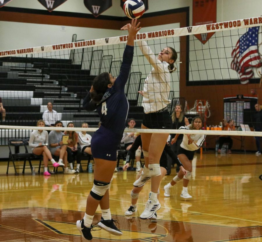 Blocking the ball from the defender, Ava Moncada 25 tips the ball over the net. Moncada was able to find the hole in the court, leading the Warriors to win a point.