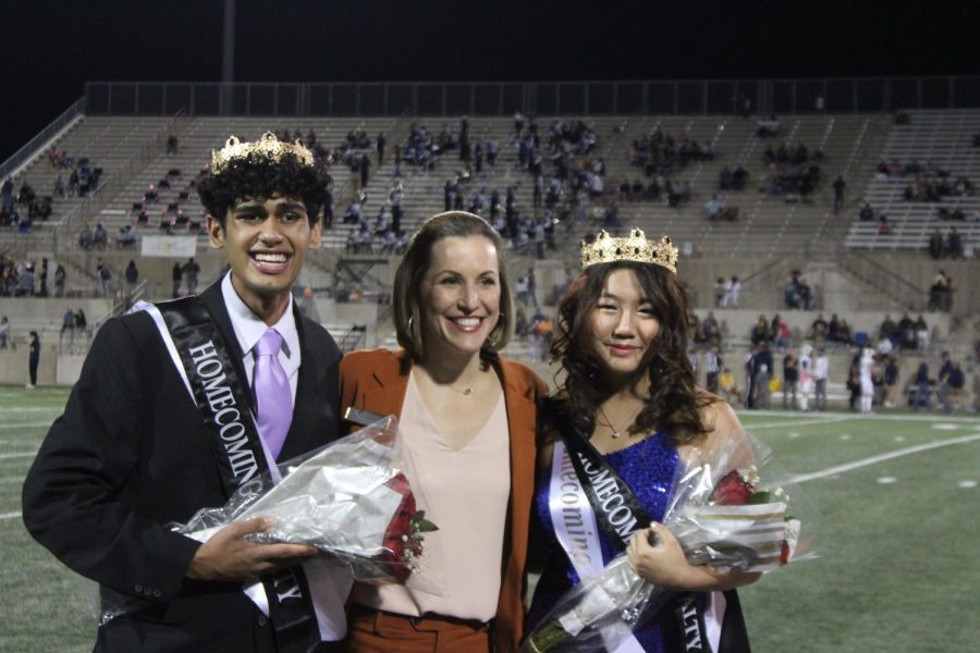 Homecoming Royalty Eshaan Chopra and Tori Xiao pose for a picture with Principal Erin Campbell after it was declared they had won the student-body vote. The two received a crown, sash, and bouquet of flowers after winning.