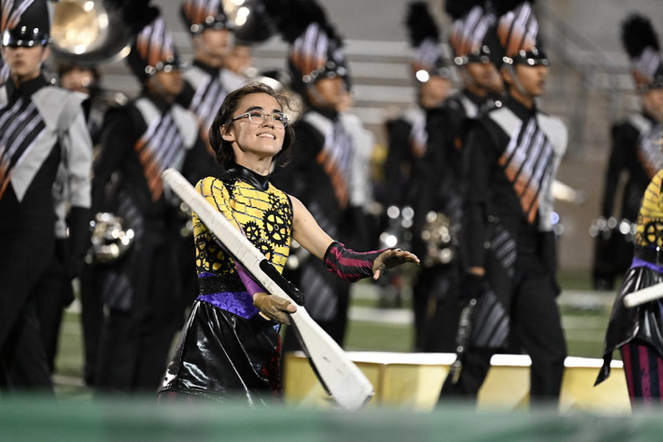 Spinning their rifle, Niko Kanda ‘25 performs for the crowd. The color guard helps add color and excitement to the field.