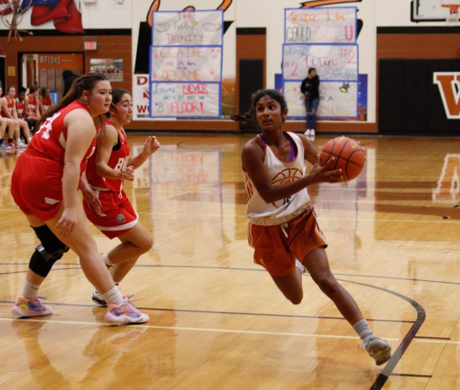 Simryn Jacob 24 drives the ball down the lane. She successfully made her layup and earned two points for the team.