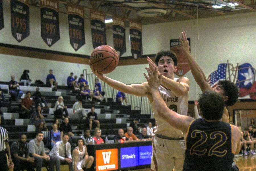 Senior, Henry Chuo, jumps over Andersons defense to make a layup. Chuo led the Warriors with five assists and nine points. 