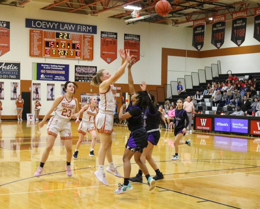 Jumping up, Emily Graham 25 shoots past the defense. Despite falling behind in the first half, the team was able to come back and win in the final few minutes of the game.