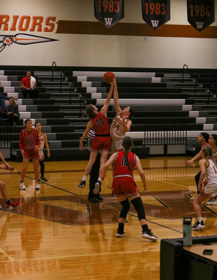 Stretching up, Grace McCluskey '26 gets a hand on the ball. Mcluskey was able to tip the ball towards a teammate, starting the game strong.