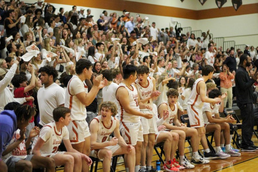 The Warriors celebrate a good play in the fourth quarter of the game. The student section was packed with fans cheering the Warriors through the first round of playoffs. 
