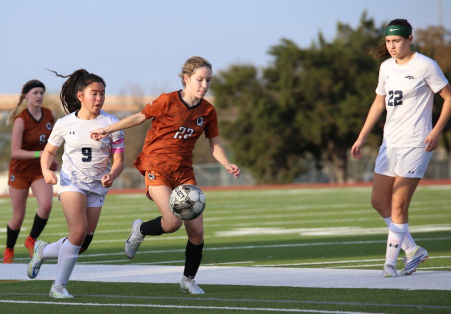 As she approaches the sideline, midfielder Kate Cotey 26 dribbles the ball from incoming opposition. Though the play resulted in a throw-in, Cotey gained a ground for the Warriors and maintained possession throughout.