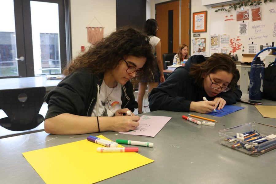Juniors Lucy Townsend and Nicole Wang make cards appreciating their art teachers. Students were able to use a variety of supplies, including markers and construction paper, to create their cards. 