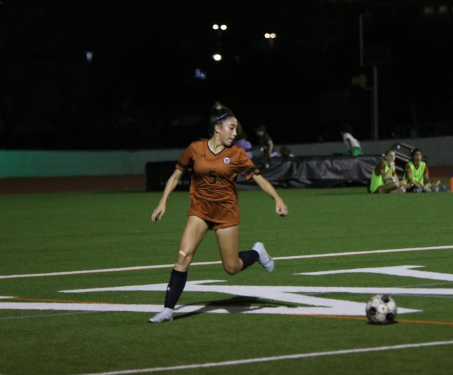 Freshman Kaleia Coughlin sprints back to keep the ball in play. With seven minutes left in the first half, Coughlin received a pass from a teammate and scored the ball far from the goal as the goalie was quickly moving out of the box.
