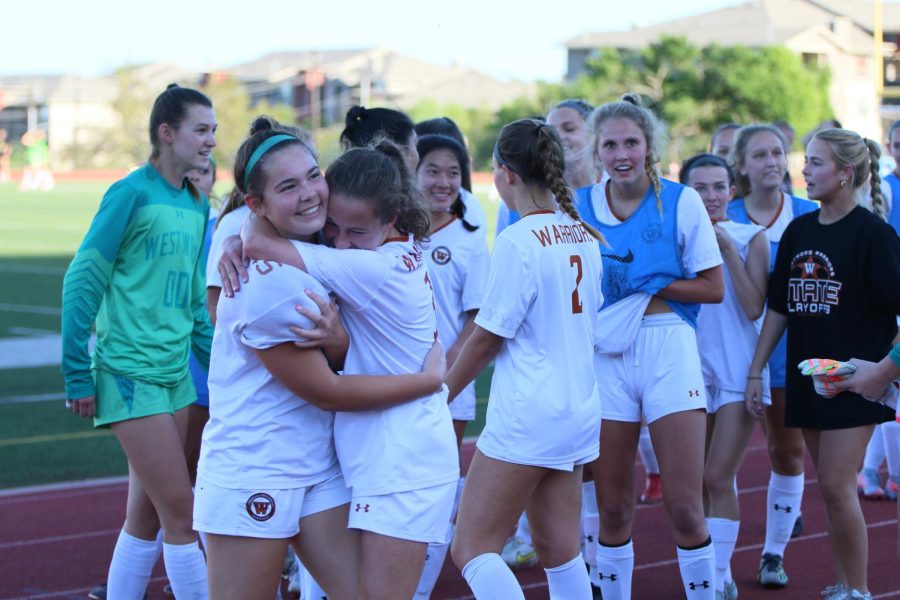 Kate Cooper 24 and Sasha Brown 23 hug each other and rejoice over the 1-0 win. After the game ended, the team ran towards the stands to celebrate with friends and family.