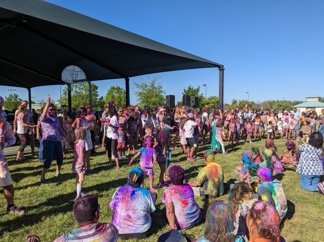 People gather around as dancers prepare to perform modern Bollywood dances. Community members gathered to celebrate Holi on Saturday, March 25. The experience was so nice just being able to dance with people that I already considered my friends, Max Bradford 25 said. 