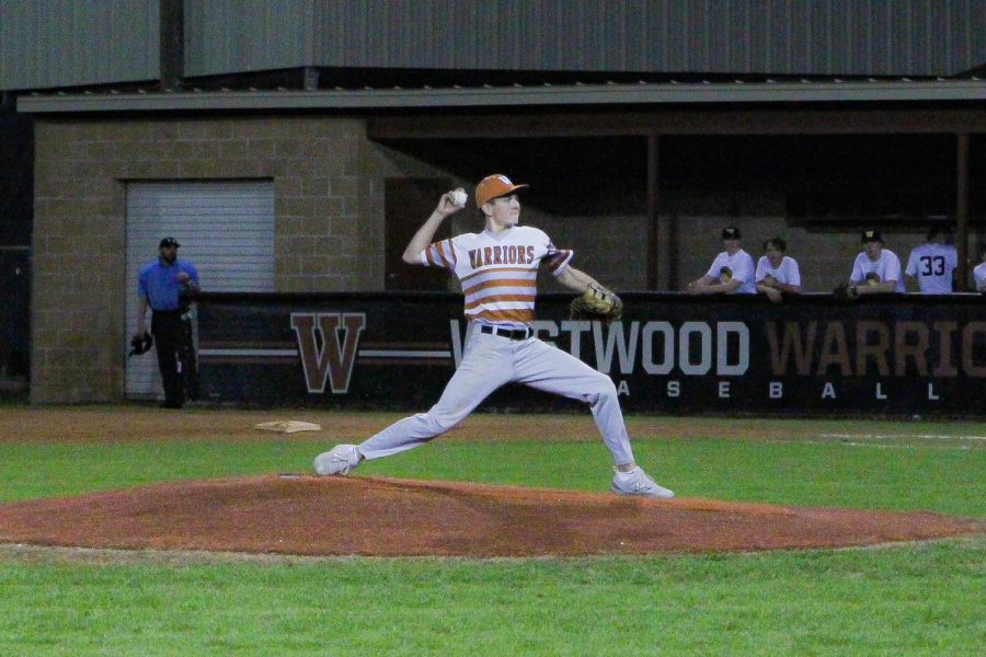 With a powerful throw, pitcher West Morgan 26 launches the ball towards the batter. 