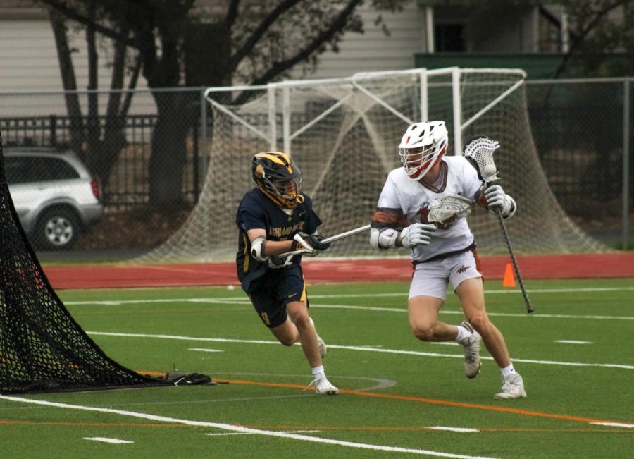 Behind the goad, Bodie Bradley 23 goes around the Highland Park defense to attempt a goal.