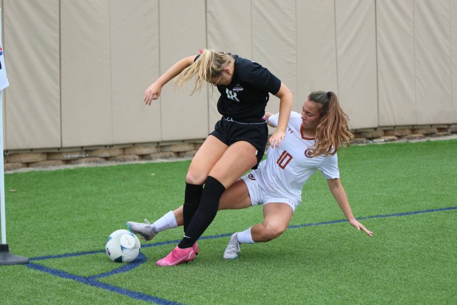 Keeping her foot on the ball to defend, Mia Wiele 26 focuses on her play. Wiele tried hard to keep the ball in bounds so that the standoff would not result in a corner kick for the other team.