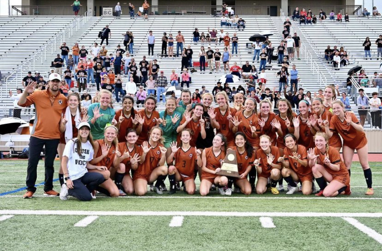 The varsity soccer girls pose after winning the round five game against Round Rock. The team advanced to the state tournament.