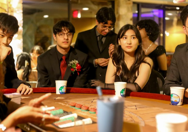 Focused, Akhil Gharpurey 23 and Annette Ho 23 play casino games at Prom. In addition to music and dancing, the event offered other activities like a photobooth and games.