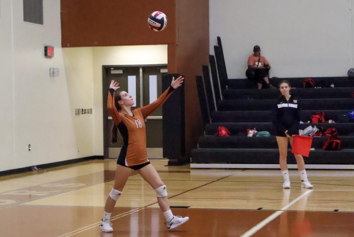 Madelyn Ivy 27 serves the ball over the net in the second set. The warriors were trying to close the gap with their strong serves. 