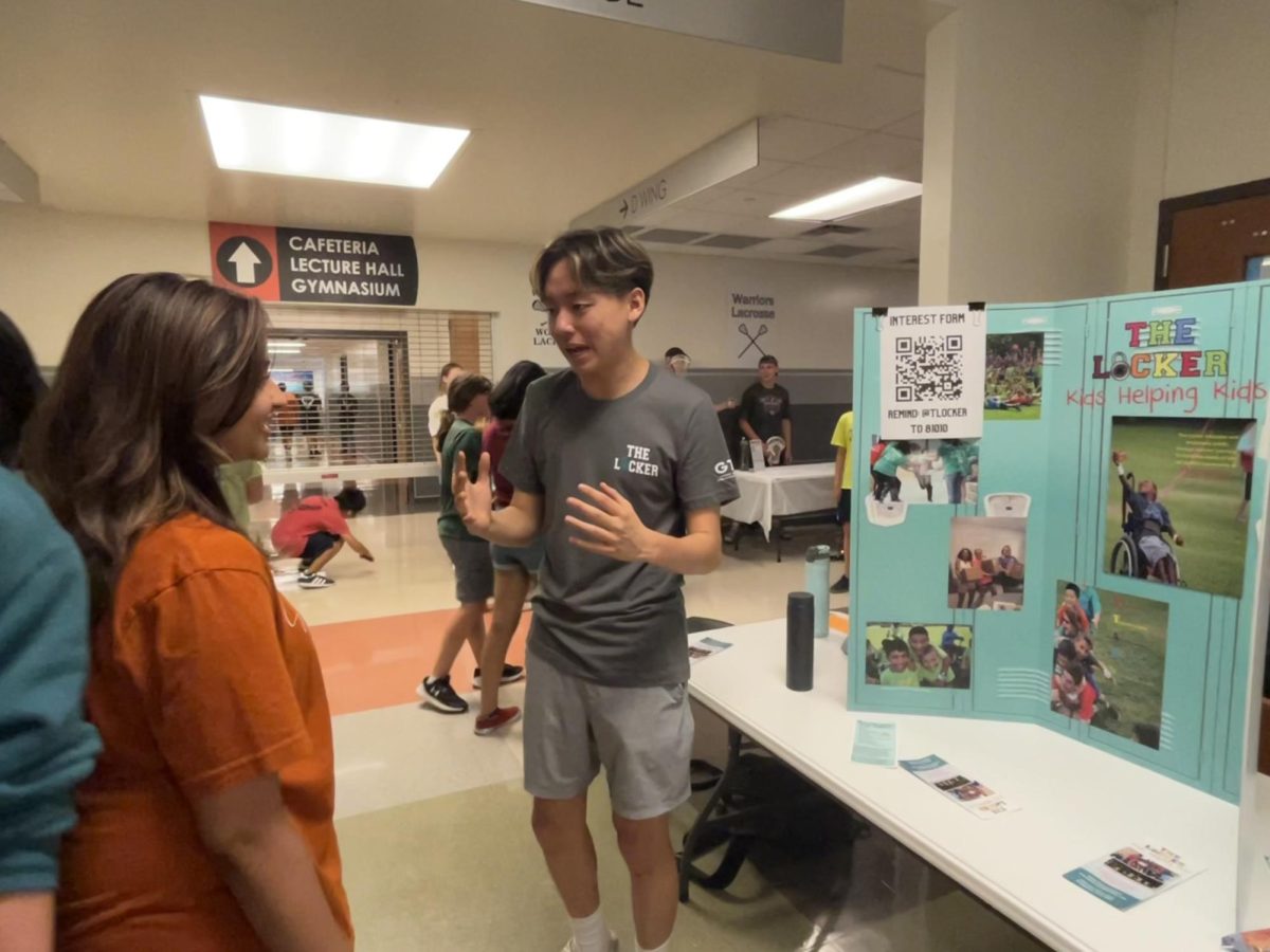 Enthusiastically, Ian Shone 25 urges freshmen to join The Locker Club. At the Fishbowl club fair, booths ran by club offers encouraged freshmen to join student organizations and get involved on campus.