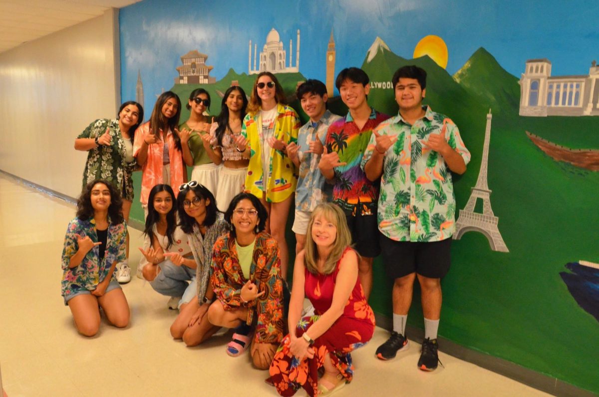 Adorning Hawaiian shirts, the Student Council officers pose in the F-hall during Beach Day. StuCo officers planned and executed Howdy Week dress-up days, which encouraged school spirit, and contained a variety of themes, making the celebration accessible to all.