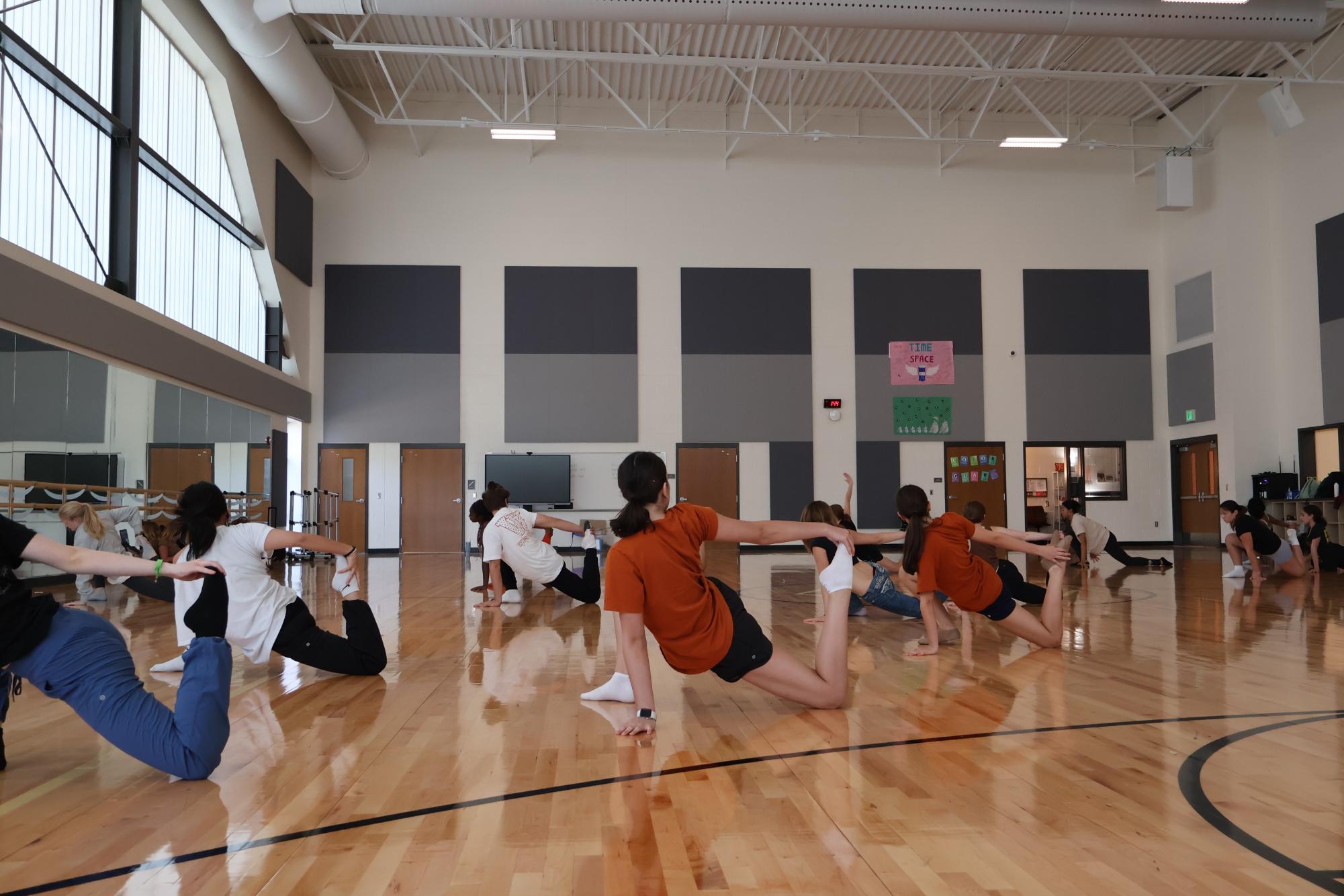Dancers stretch in preparation for choreography and dancing. 