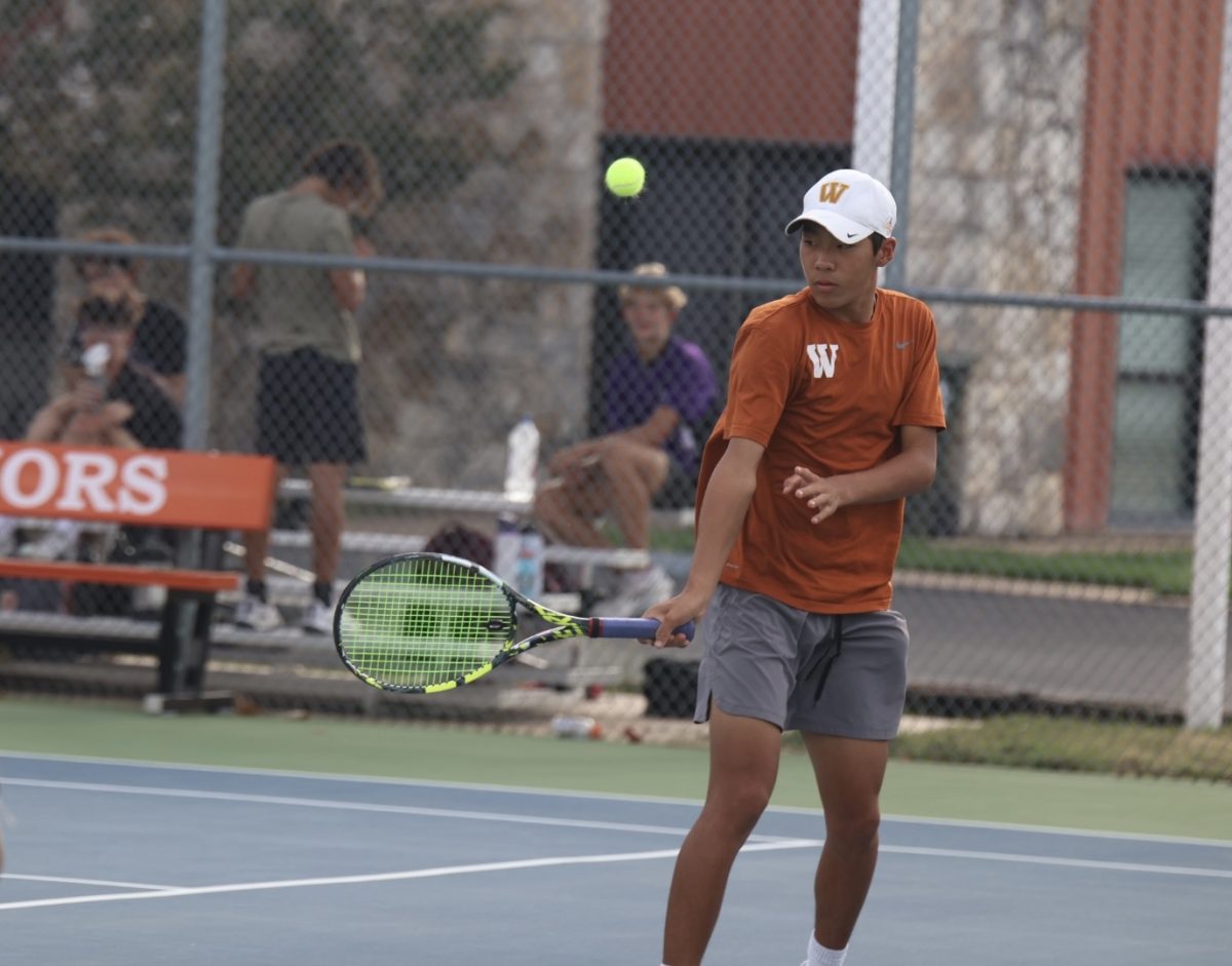 Daniel Zhang 26 reaches for the ball during his doubles match with Arjun Rajan ‘25. 