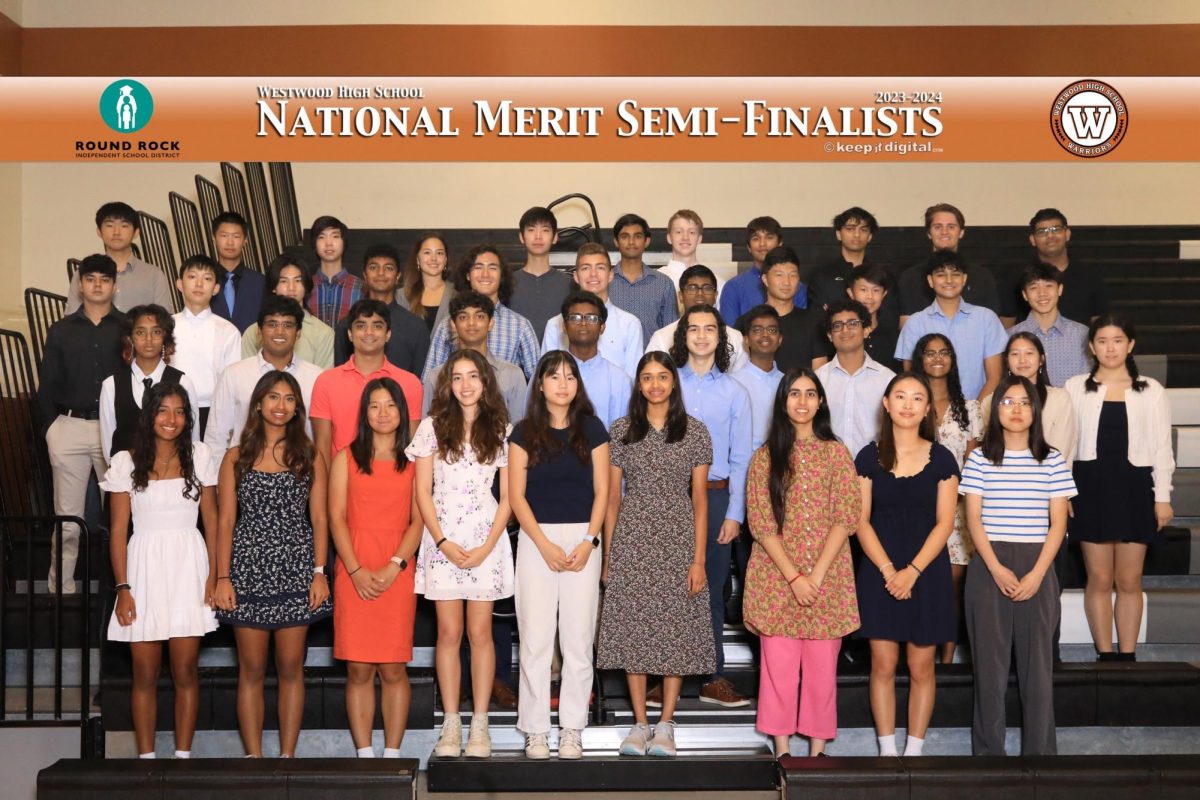 Standing on the bleachers in the small gym, Westwoods National Merit semi-finalists pose for a photo after the awards ceremony. The biggest group of winners in Round Rock ISD, a total of 45 seniors won this award: a result of scholarly dedication and diligence.