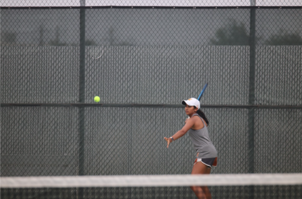 With a powerful windup Rachana Akkineni ‘26 gets ready to hit a forehand during her singles match. The Warriors came into the game on a 5 game win streak and looked to extend that to six games.