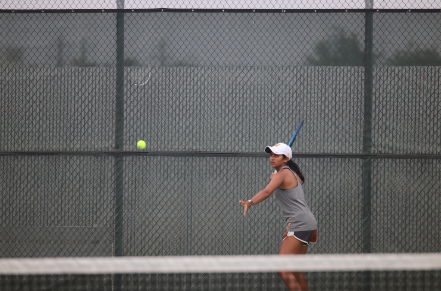 With a powerful windup Rachana Akkineni ‘26 gets ready to hit a forehand during her singles match. The Warriors came into the game on a 5 game win streak and looked to extend that to six games.