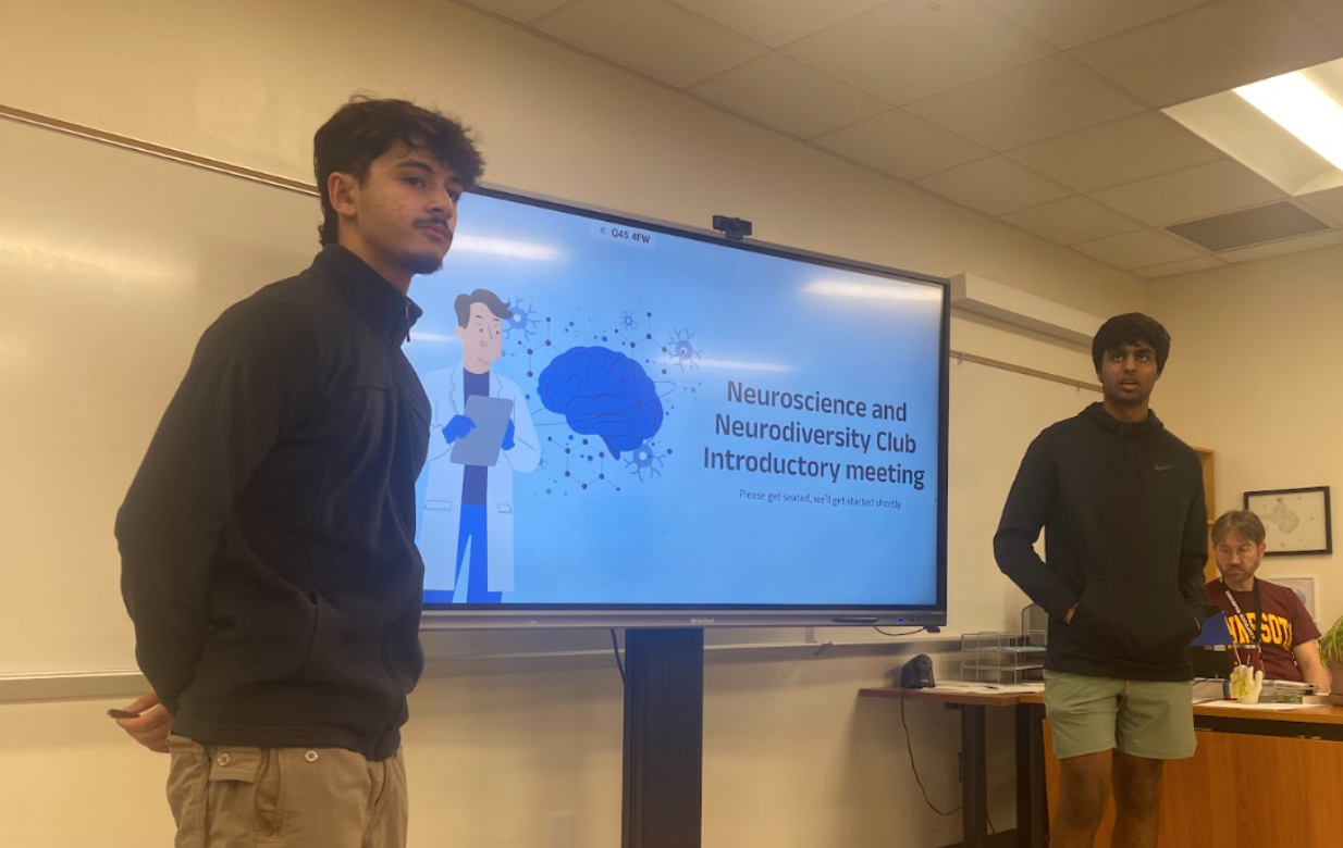 Engaging their audience, officers Akhilesh Pissay 24 and Zane Salman 25 introduce essential Neuroscience and Neurodiversity club information to members.