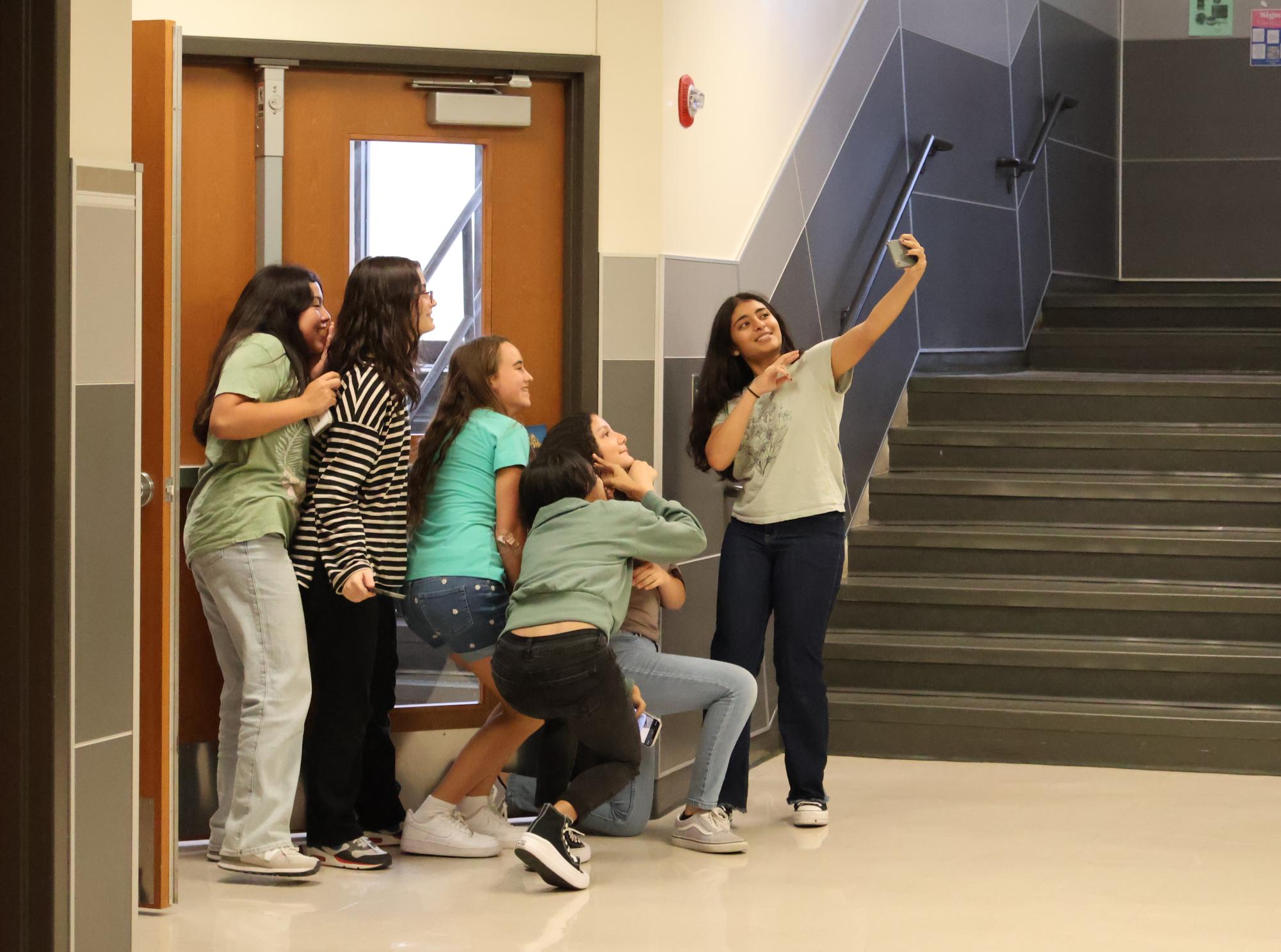Posing for a selfie, a group of French Club members search the F-wing for pictures of French monuments in a scavenger hunt. To prove they found each image, groups had to take a photo of them with the monument.