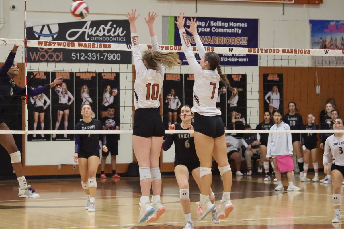 Olivia Hendricks 24 and Ava Moncada 25 block Cedar Ridges spike. Blocks such as these earned the Warriors many points during this match.