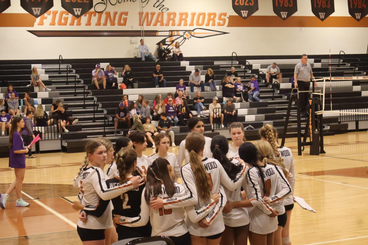 Focused and ready, the Lady Warriors have a pep talk during a time out in the second set. The Warriors would go on to win the set and completed the sweep against their district foes.