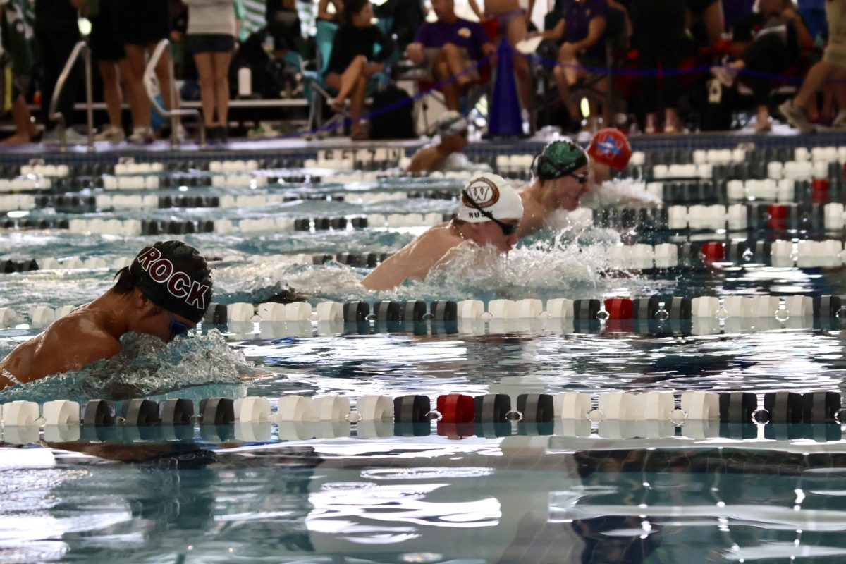 Breaths in sync with his opponents, Julian Rusk 27 glides through his 100-yard-breastroke. The 100-yard breaststroke was one of the most heated competitions of the day.