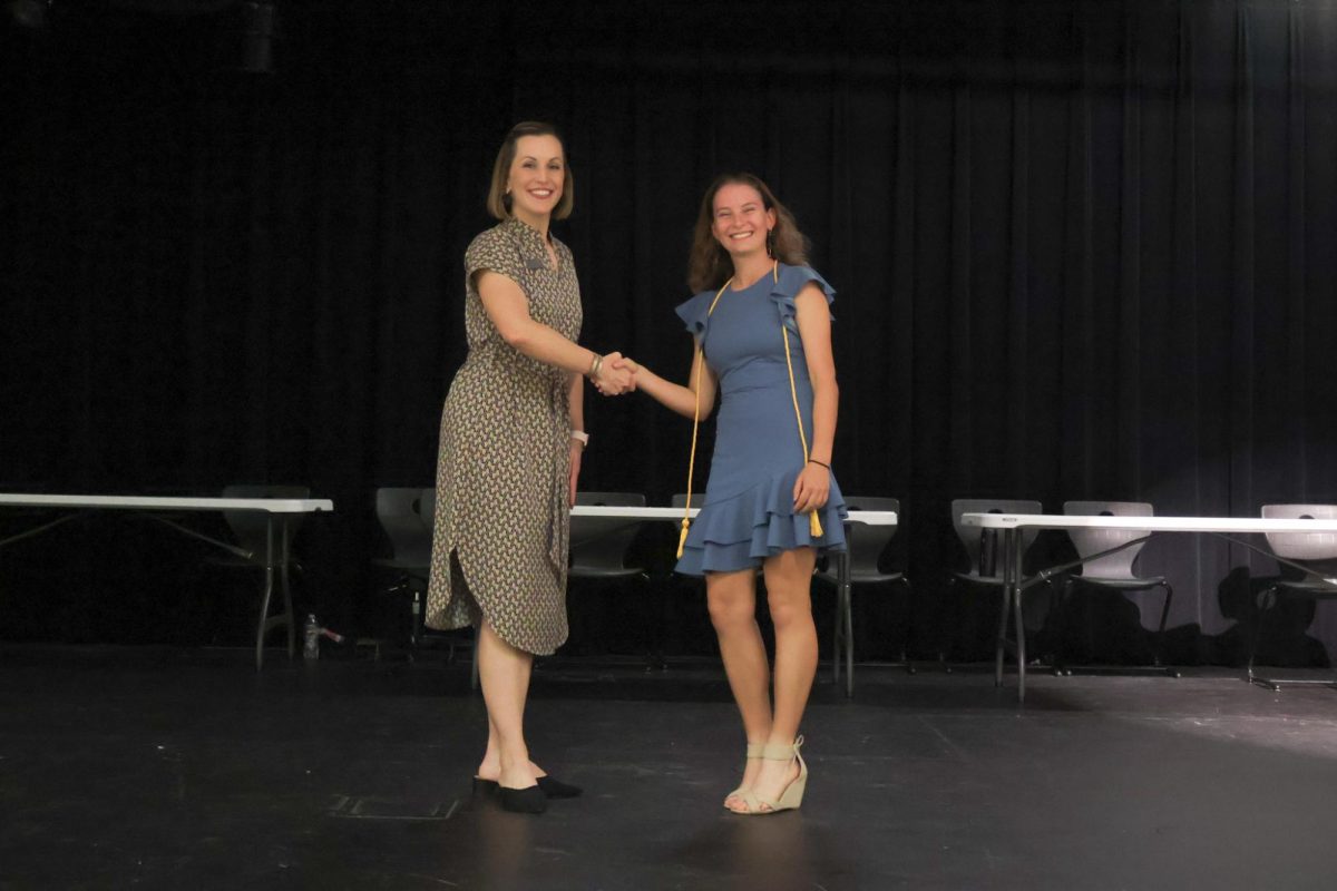 Aleks Tremmel 25 shakes Principal Erin Campbells as she gets inducted into National Honor Society. The induction ceremony was on Thursday, Oct. 12. “At first I felt nervous walking across the stage but then I felt determined and excited knowing all my peers and I had worked hard for this,” Tremmel said. 
