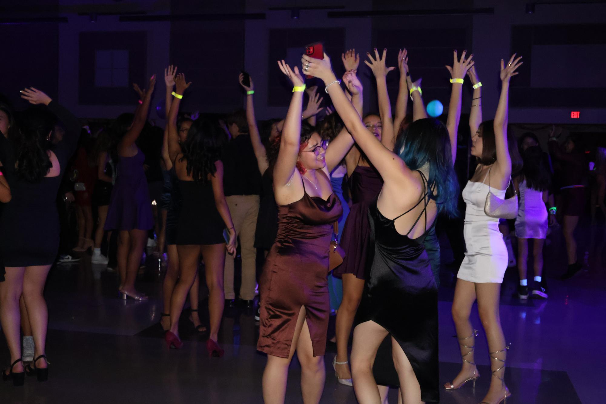 On+Saturday%2C+Oct.+21%2C+students+gathered+in+a+transformed+cafeteria+to+dance%2C+play+casino+games%2C+and+unwind+with+fellow+peers+at+the+annual+Homecoming+Dance.%C2%A0This+year%E2%80%99s+theme+was+%E2%80%9CLet%E2%80%99s+Glow+Crazy%E2%80%9D+and+the+campus+was+decked+out+with+blacklight+and+neon+illustrations+to+represent+it.