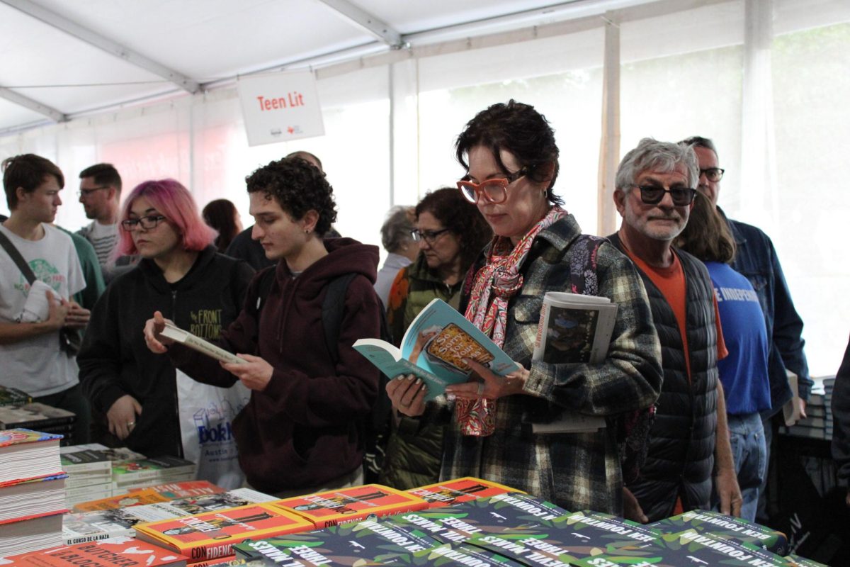 Readers browse through the books available for purchase at the Texas Book Festival. After attending author panels, readers could purchase books from the authors they just listened to and get their new books signed.
