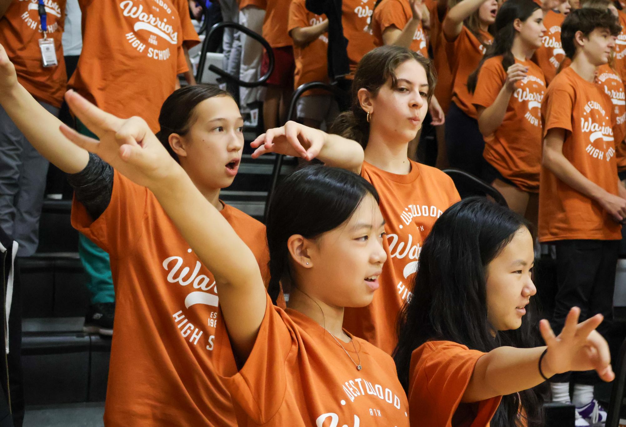 Learning the school symbol, a group of 8th graders practice the sko wood slogan. During the pep rally, 8th graders were introduced to Westwood spirit attributes.