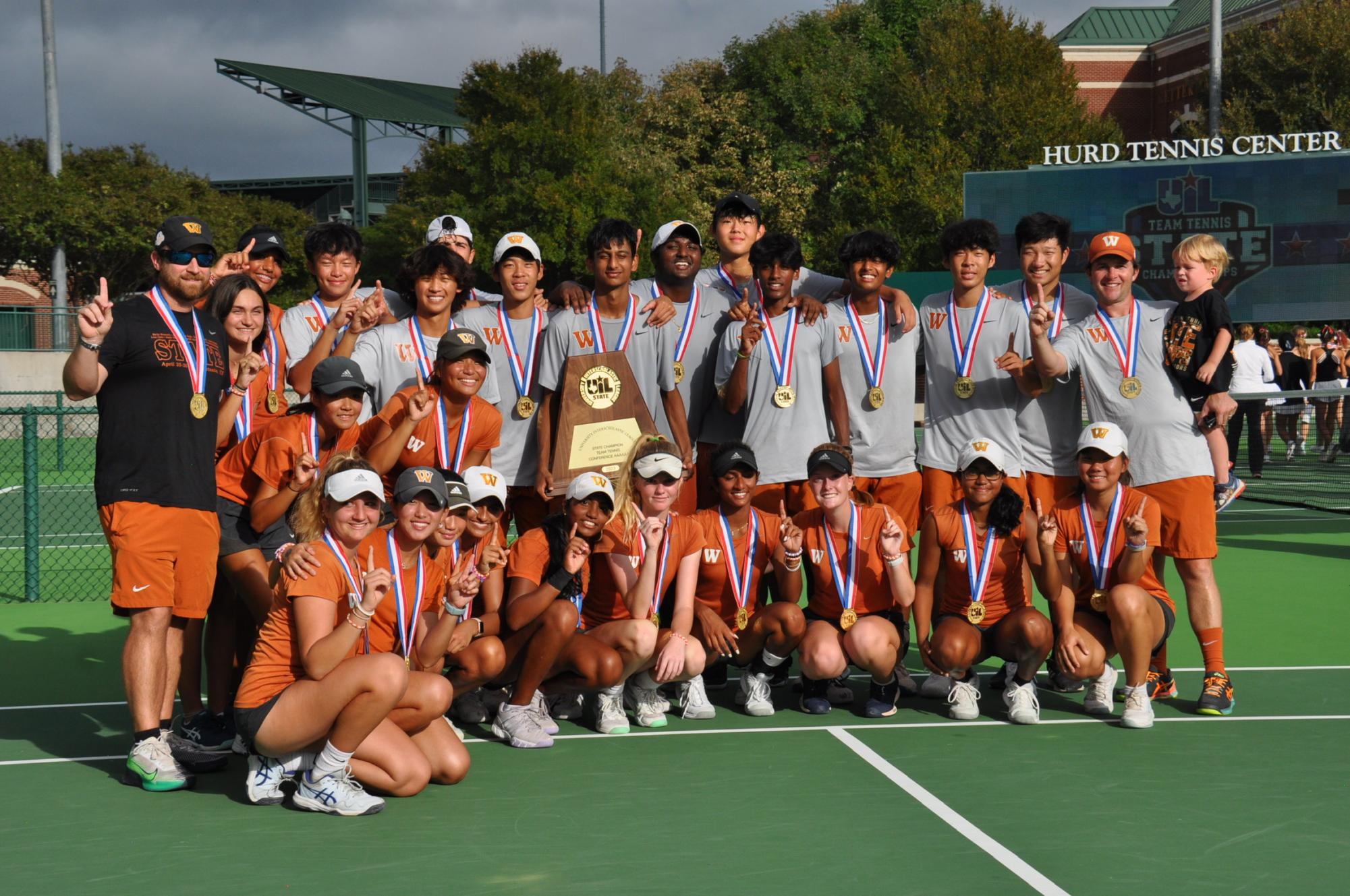 Posing for a photo with their State Championship trophy, the varsity tennis team celebrates victory after a 10-3 win against Houston Memorial Mustangs. This year marks the first time the team has won the title two years in a row. Players attributed the win to dedication, practice, and community.
