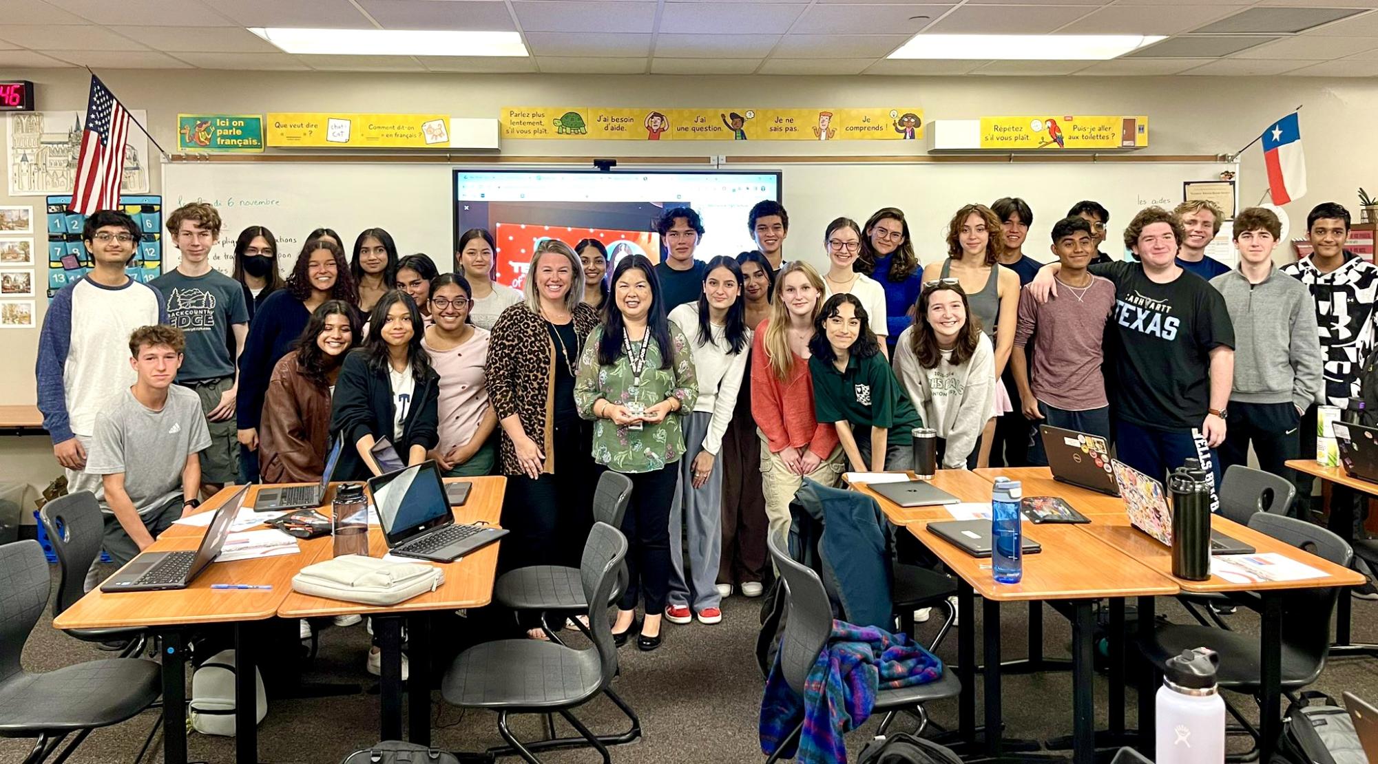 Holding her trophy, Madame Macharia poses for a photo with her fifth block class. On Nov. 4, Mme Macharia was named the Texas Foreign Language Teacher of the Year at the Texas Foreign Language Association Conference.