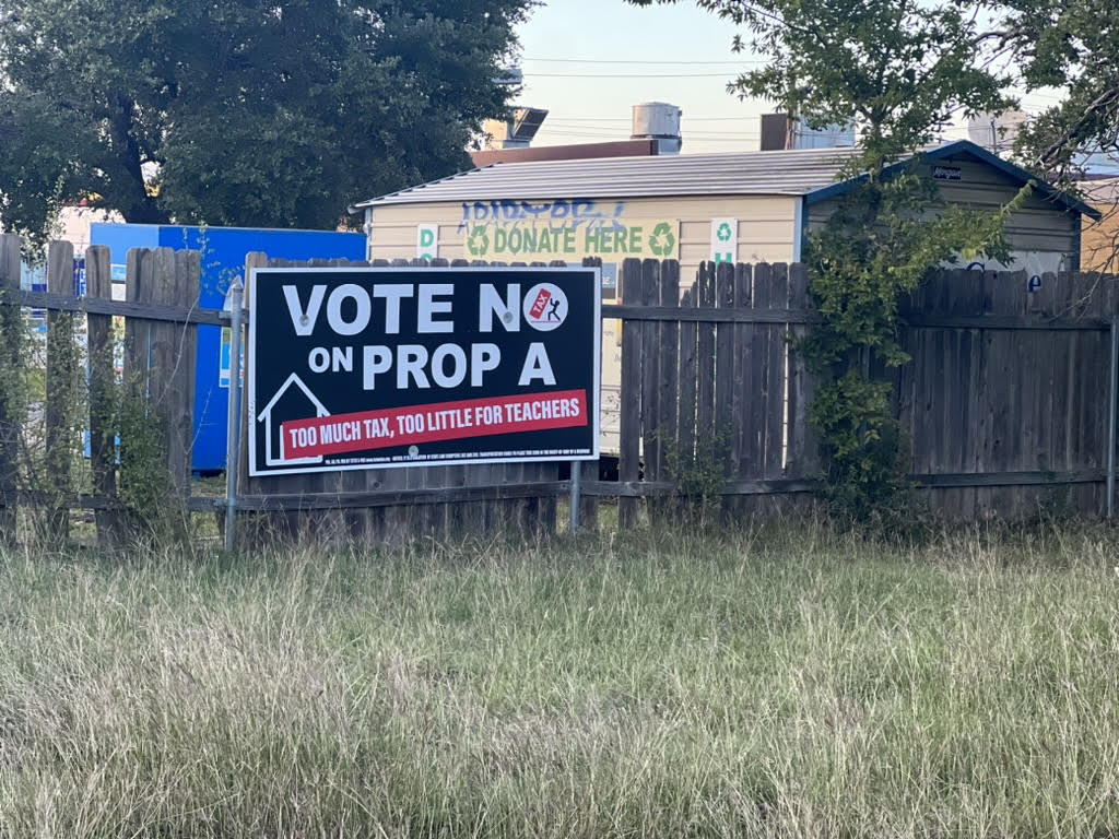 An anti-Proposition A (Prop A) political poster plastered behind a gas station. These types of ads are distributed and paid for by the Travis County Taxpayers Union. The election for the passage of Prop A is on Tuesday, Nov. 7.