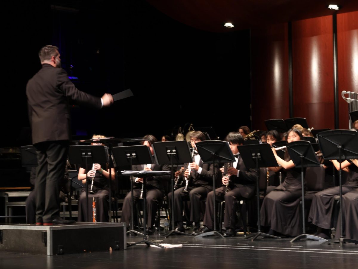 Conducting%2C+Band+Director+Thomas+Turpin+leads+the+Wind+Ensemble+at+their+sendoff+concert.+The+Wind+Ensemble+was+chosen+to+perform+at+a+highly+selective+program%2C+the+Midwest+Clinic.+%E2%80%9CI+don%E2%80%99t+think+there+is+even+a+word+in+the+dictionary+to+describe+the+emotion+I%E2%80%99m+feeling%2C%E2%80%9D+Mr.+Turpin+said.+%E2%80%9CProud%2C+absolutely%2C+I%E2%80%99m+honored+to+share+the+stage+with+these+young+artists.%E2%80%9D+%0A
