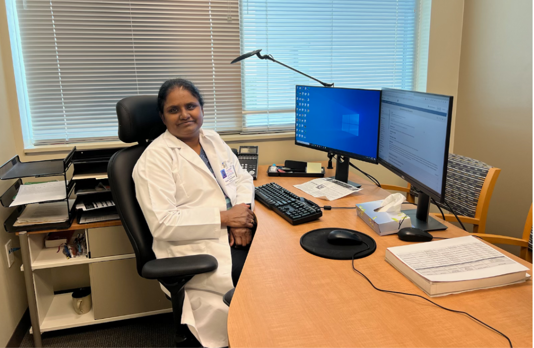 Smiling%2C+endocrinologist+Dr.+Deepa+Ponnusamy+sits+at+her+office+desk.+Ponnusamy+is+one+of+many+medical+professionals+to+start+implementing+remote+visits+for+patients+into+her+job+following+the+pandemic.+%E2%80%9C%5BRemote+visits+are%5D+huge%2C+because+it+feels+like+people+who+live+far+away+are+able+to+afford+care%2C+%5Bdue+to%5D+a+hybrid+of+%5Bremote%5D+visits+and+face-to-face+visits%2C%E2%80%9D+Dr.+Ponnusamy+said.+Photo+courtesy+of+Dr.+Deepa+Ponnusamy