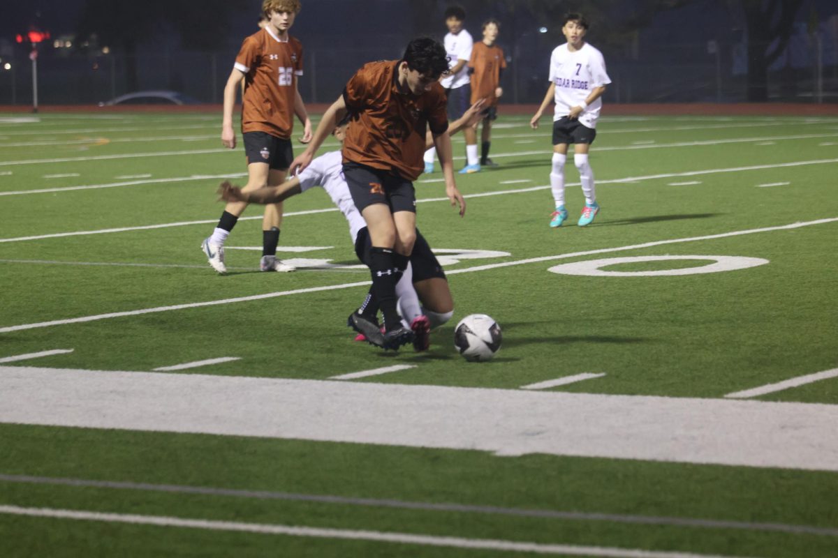 Lucas Casco 27 defends against a Cedar Ridge Raider. The Warriors were able to keep the Raiders out of their half for most of the game with good defense. 