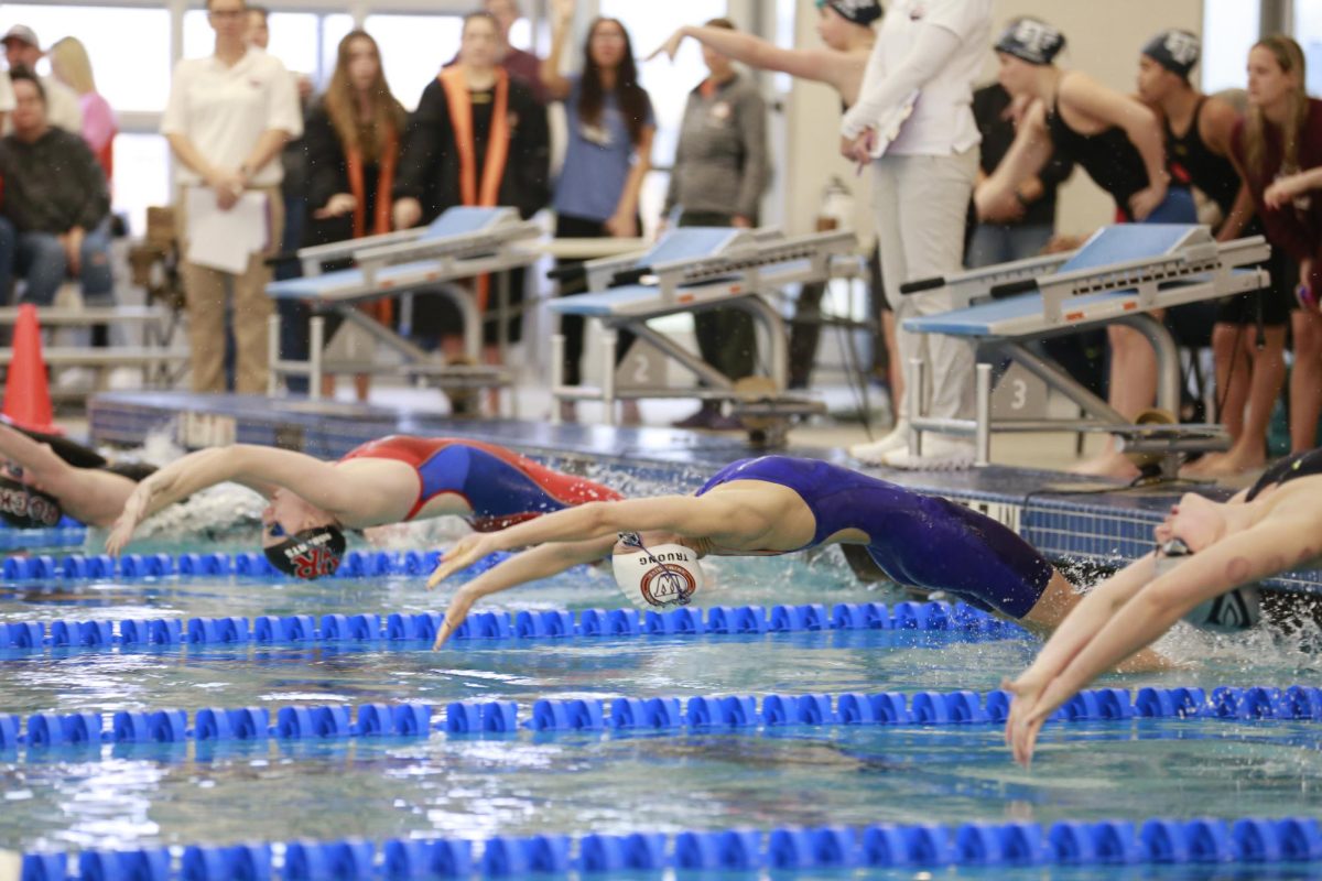 Arching back, Namanh Truong 26 starts off the 200-Yard-Medley Relay. Westwood Girls clutched first place in this event. 