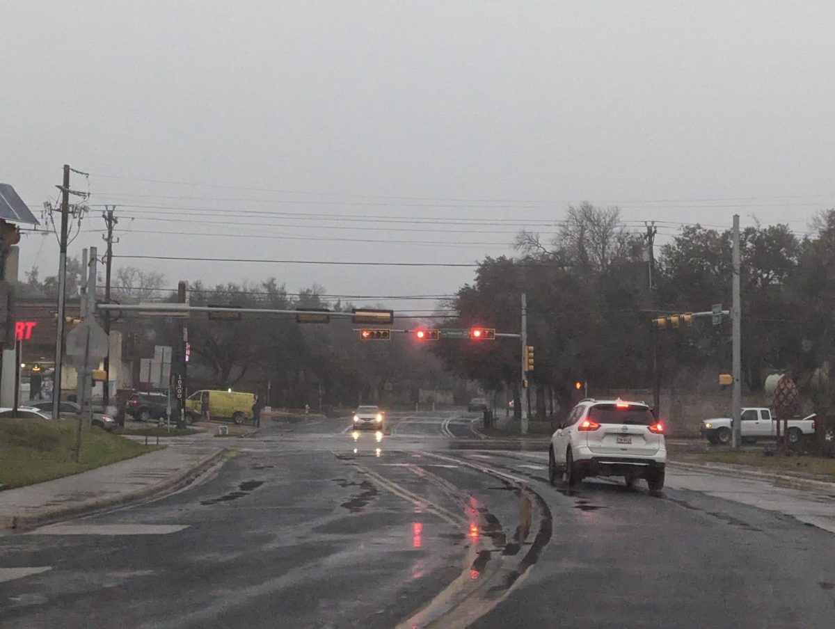 The road is full of puddles on Wednesday morning during a heavy shower. Rainfall during the night and early morning contributed to slippery conditions when students drove to school.