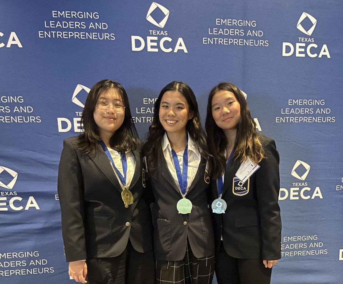 Posing for a photo, DECA seniors Brooke Xu, Valerie Zhang, and Hannah Lee relax after qualifying for the State competition. Westwood DECA beat personal records this year, having a total of 256 members advancing to compete at the next level. 