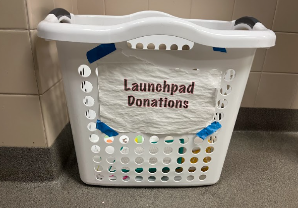 In a womens restroom, a repurposed laundry bin stores menstrual products for people to use, an effort to combat period poverty. Since its founding in 2018, LaunchPad has worked with HOSA to collect and distribute menstrual products around Westwoods restrooms for students use.