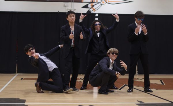 Showing their personalities, Mr. Warrior contestants strike a pose at the end of their group dance. The Mr. Warrior group dance was choreographed by members of StuCo and performed by the competitors to show the friendly nature of the competition. 